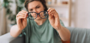 The girl looks at the glasses checking for dirt