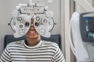 Close-up Of african teen girl Doing Eye Test On Phoropter, Afric