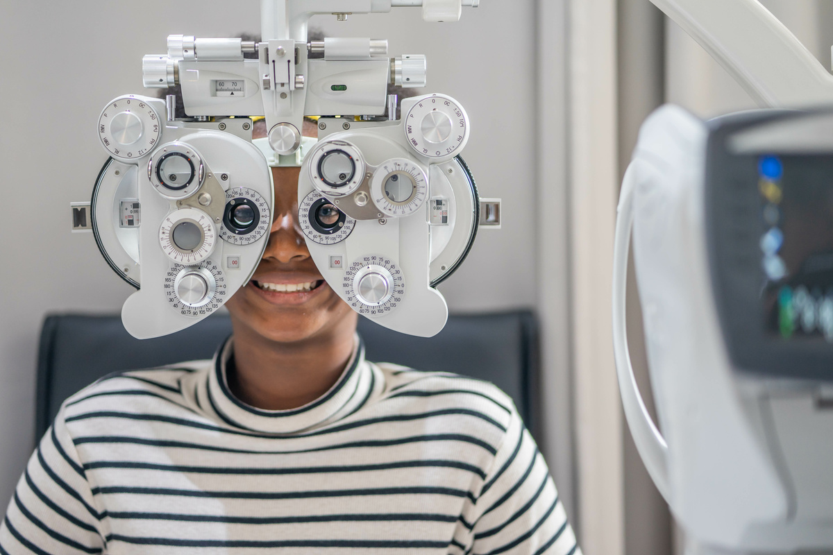 Close-up Of african teen girl Doing Eye Test On Phoropter, Afric