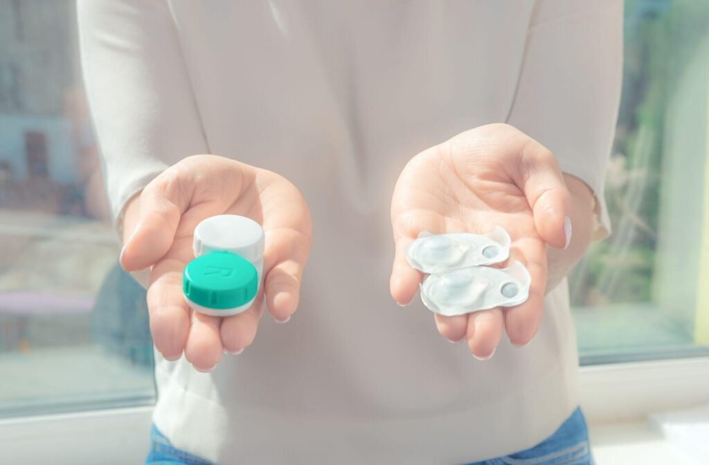 a person holding contact lens in their hands