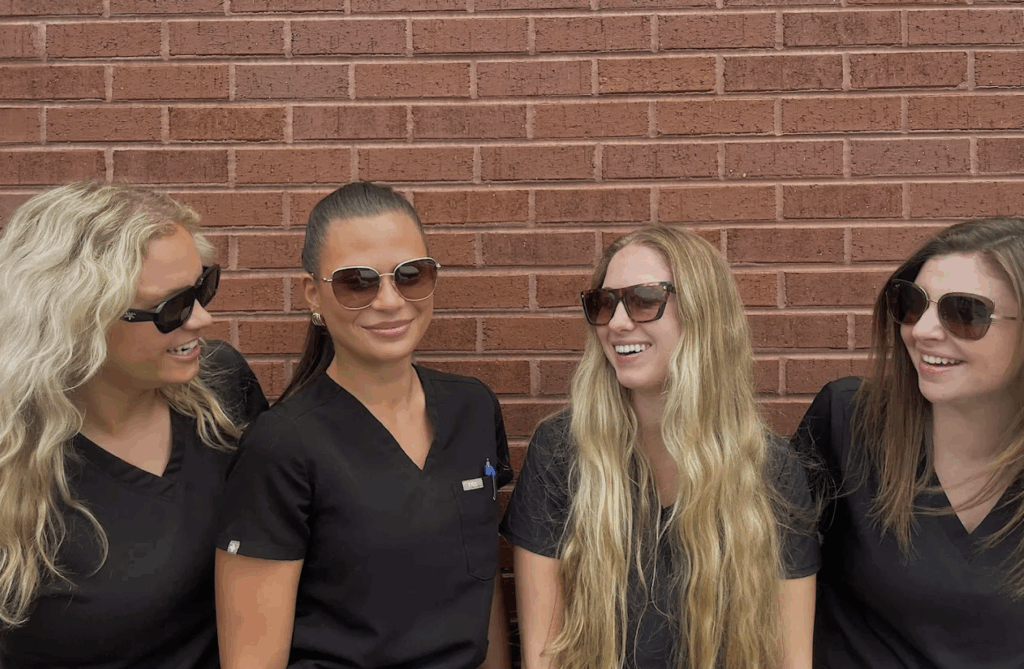A group of Karn's Vision Centre optical team wearing different pairs of sunglasses